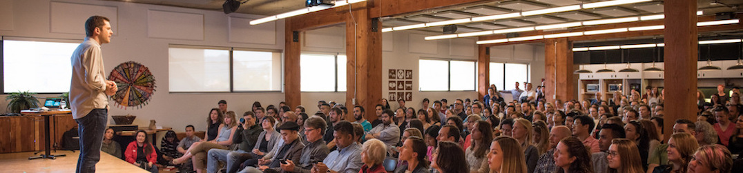 Chris Guillebeau speaking to a packed crowd