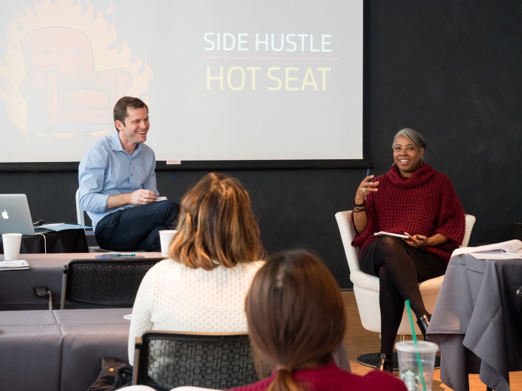 Side Hustle School live workshop in Portland — Chris on stage with a guest, discussing their side hustle