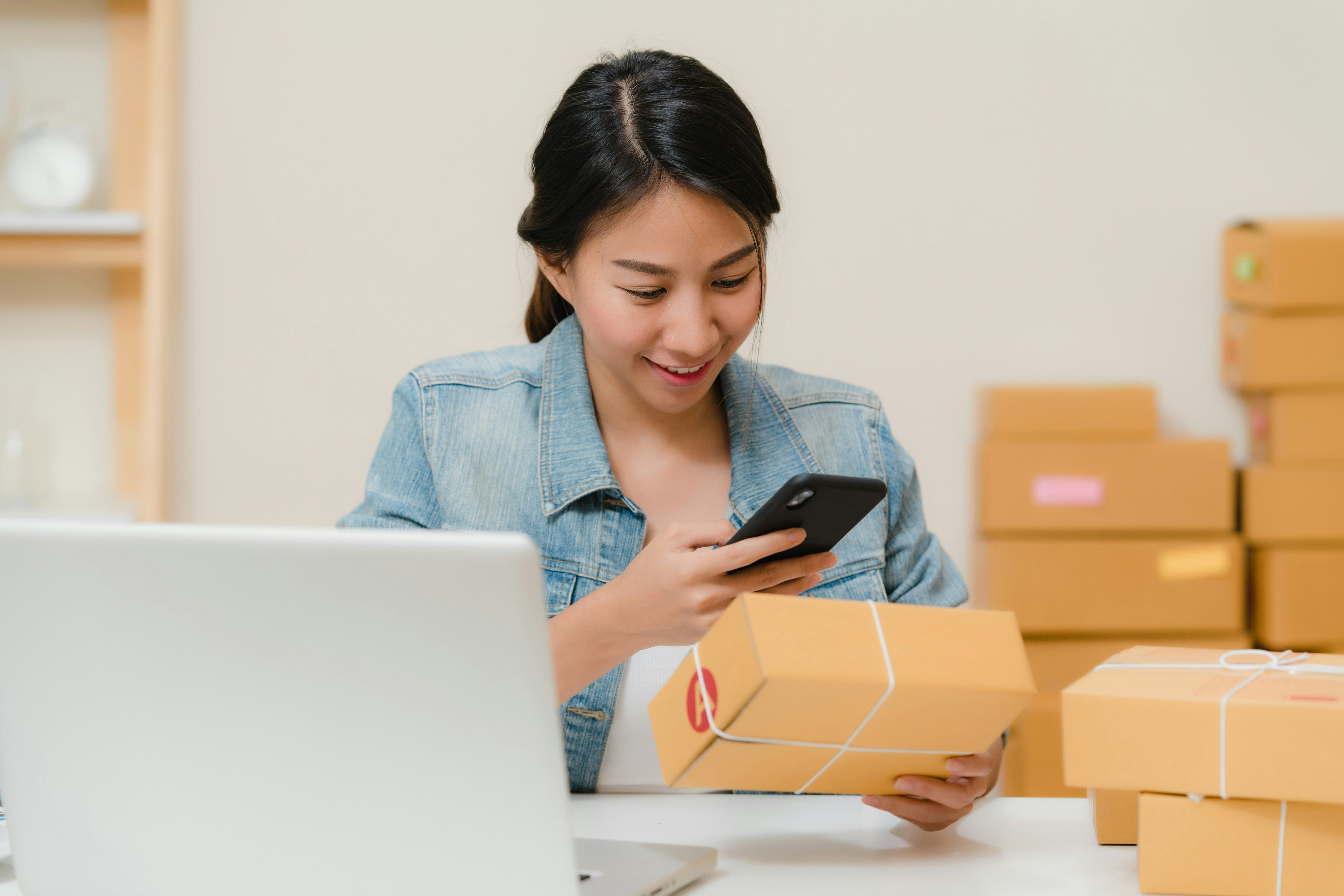 Woman checking a package, preparing an order for shipment